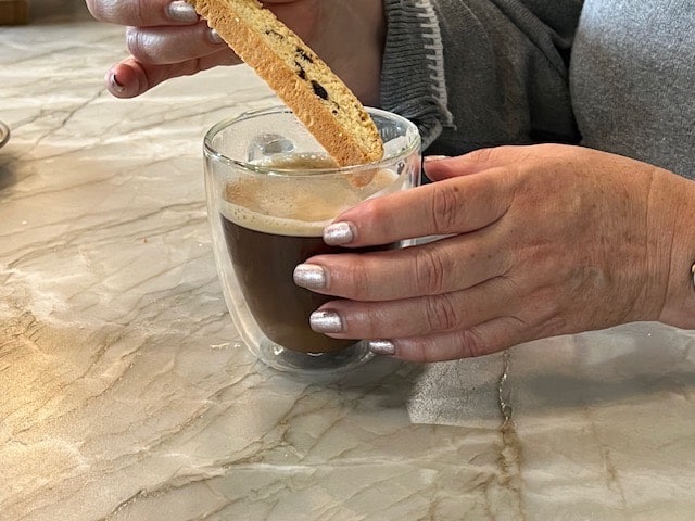 Biscotti being dipped into a cup of coffee