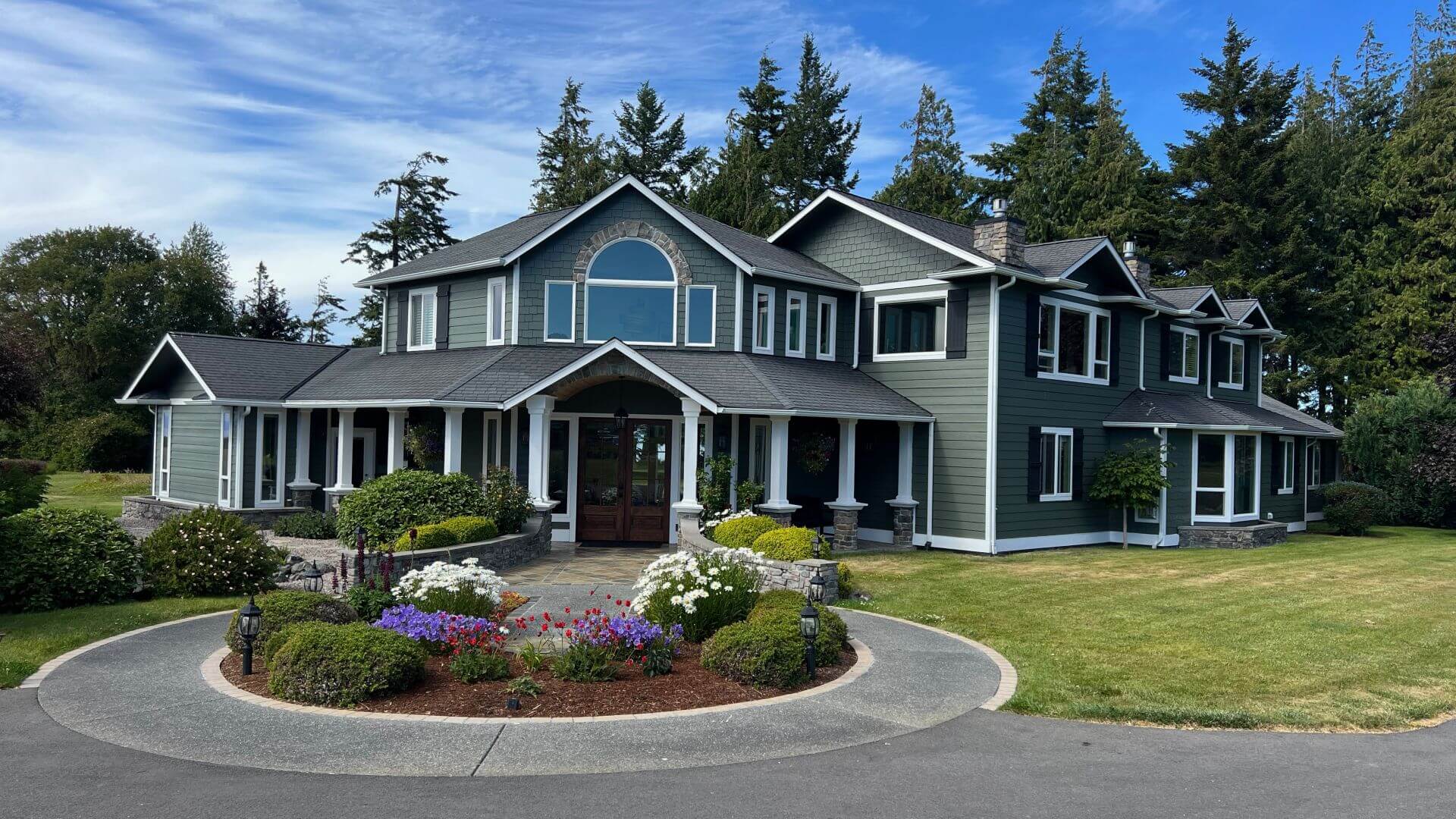 Exterior front view of inn showing circular flower garden and grass