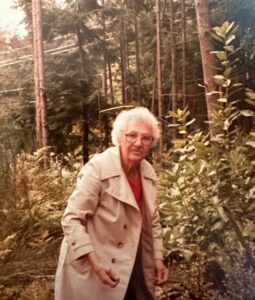 Grandma Baker walking in a forested area