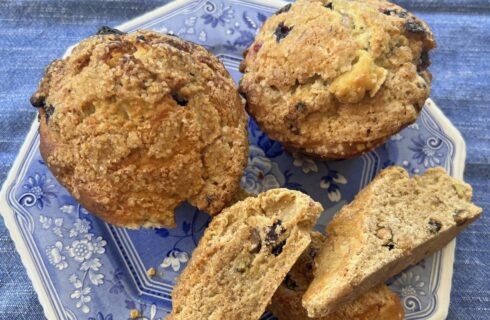 Close up view of muffins and scones on a blue plate