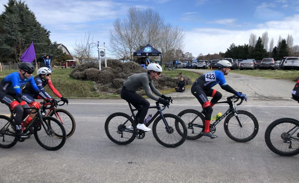 People racing on bikes on paved road